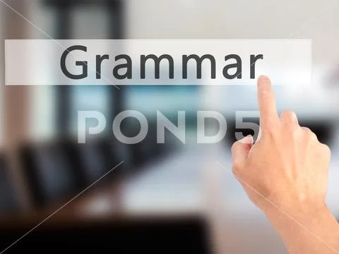 Grammar - Hand pressing a button on blurred background concept o Stock Photos