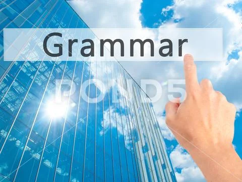 Grammar - Hand pressing a button on blurred background concept o Stock Photos