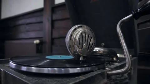 The gramophone needle plays on an old vinyl record. The vinyl record is spinning Stock Footage 260975492