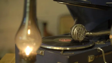 Gramophone with a vinyl record in a retro interior, a kerosene lamp is burning Stock Footage 81361227