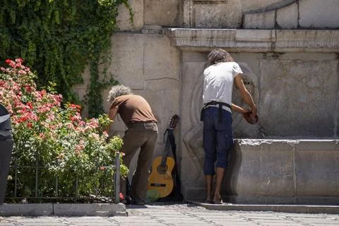 Granada, Granada, Spain - August 05, 2023: Street musicians washing the dishes Stock Photos