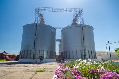 Granary elevator on blue sky background. Silos, crops storage Stock Photos