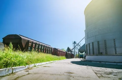 Granary elevator on blue sky background. Silo, crops storage Stock Photos