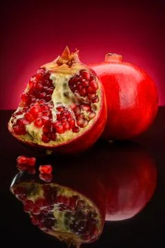 Granate on a dark red background Stock Photos