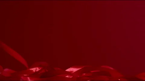 Granate silk ribbon falling down on a red background. FHD still high quality Stock Footage 146168732