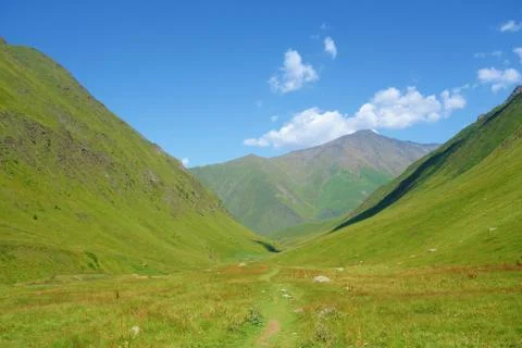 Grand alpine mountain range during summer on a hiking trail leading from Juta Stock Photos