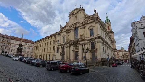 Grand Baroque Facade of St. Nicholas Church on Lesser Town Square with Cars Video stock 323738329