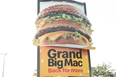 Grand big mac back for more mcdonalds poster ad on post with picture of big mac Stock Photos