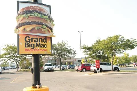 Grand big mac back for more mcdonalds poster ad on post with picture of big mac Stock Photos