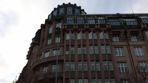 A grand building with a rounded corner tower and rich architectural detailing. T Stock Footage 300114628