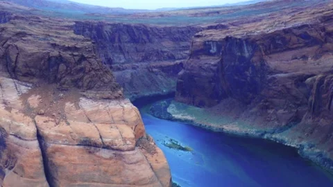 Grand canyon river bend dramatic cliffs vivid sandstone layers deep blue water n Stock Footage 311648968