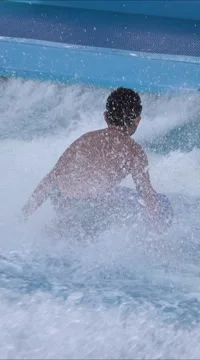 Grand Cayman cruise ship boy knee board surfing vertical HD 054 Stock Footage 58564344