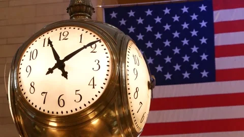 Grand Central Terminal clock, 42 street New York USA. Flag inside railway Stock Footage 325687161