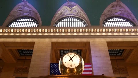 Grand Central Terminal clock, 42 street New York USA. Flag inside railway 스톡 동영상 333095373