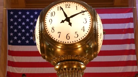 Grand Central Terminal clock, 42 street New York USA. Flag inside railway Stock Footage 333521440