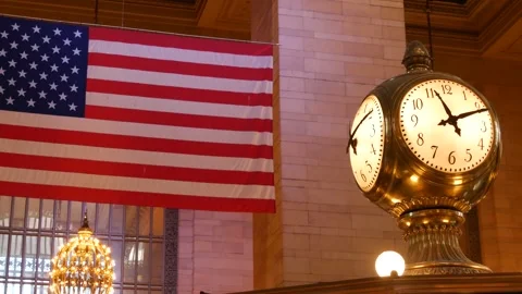 Grand Central Terminal clock, 42 street New York USA. Flag inside railway Stock Footage 335132776