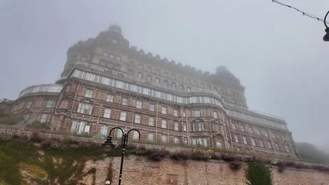 Grand Hotel Emerging through Dense Coastal Fog 库存影片 346751327