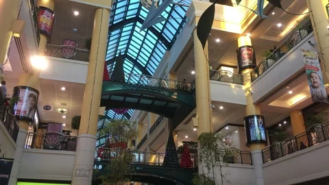 Grand Multi Level Shopping Mall Atrium with Glass Skylight and Christmas Trees Stock Footage 340148934