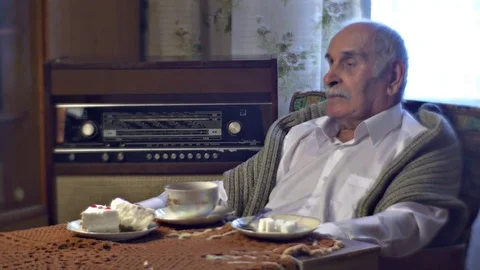 Grandad Setting Radiogram in Lunch Time Tea Cup Cake Piece on the Table in Cosy Stock Footage 72229190