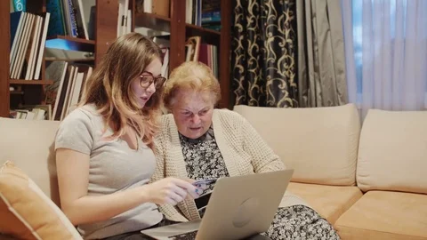 Grandaughter learning how to use laptop computer and credit card Stock Footage 71400810