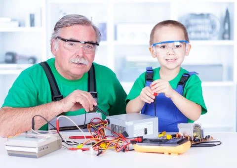 Grandchild disassembling PC power supply Foto stock