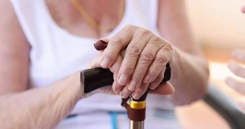 Granddaughter hugging grandmother hands with cane closeup 4k movie slow motion Stock-Footage 195263076