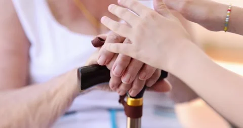 Granddaughter hugging grandmother hands with cane closeup 4k movie slow motion Stock-Footage 278581611
