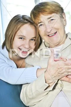 Granddaughter visiting grandmother Stock Photos