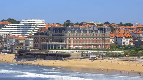 Grande Plage beach and oceanfront of the Hotel du Palais on a sunny day Stock-Footage 341597289