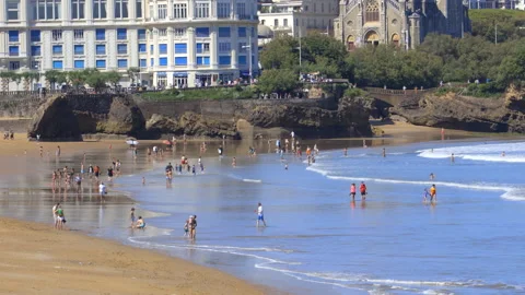 Grande Plage beach at low tide with swimmers in Biarritz, France Vidéo 340209312