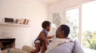 Grandfather And Grandson Playing Game On Sofa At Home Stock Footage