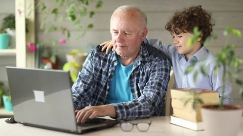 Grandfather and grandson study on the computer at home ,back to school Stock Footage 200682889