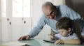 Grandfather and grandson using digital tablet together HD Footage