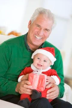 Grandfather With Baby In Santa Outfit Stock Photos