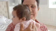 Grandfather Holding Baby Granddaughter In Slow Motion Stock Footage