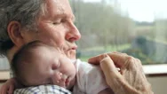 Grandfather Holding Sleeping Newborn Baby Granddaughter Stock Footage