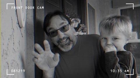 Grandfather Holds Grandson and Waves to Doorbell Camera Stock Footage