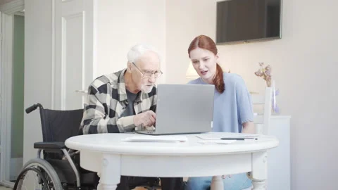 Grandfather learns to use laptop while granddaughter helps him Stock Footage 173497927