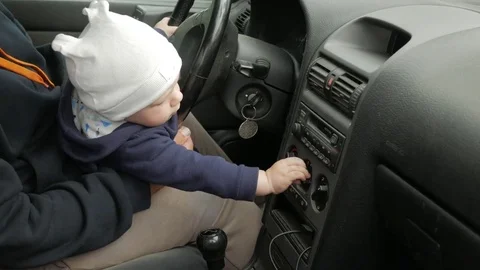 Grandfather plays with the boy in the car while driving. The grandson is very Stock Footage 76976629