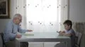 grandfather reading a book while baby playing with a tablet - ancient vs modern HD Footage