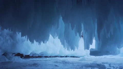 Grandiose icicles, sharp ice floes, narrow cave winter frozen Baikal lake Russia Video stock 165664110