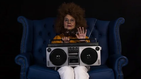 Grandma dj cool woman retired elderly music party ghettoblaster Stock Footage