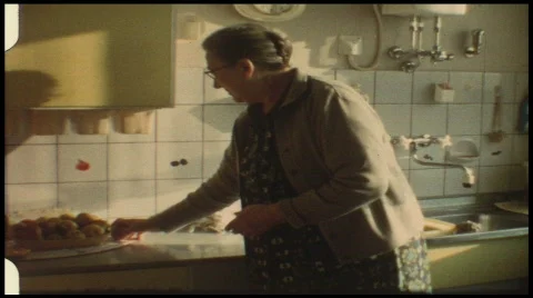 Grandma in kitchen (vintage 8 mm amateur film) Stock Footage