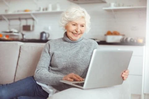 Grandma learns how to work with a computer at home Stock Photos