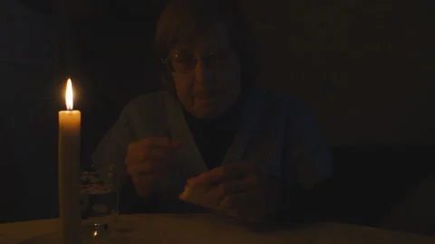 Grandma is sitting at the table. Stock Footage 209264422