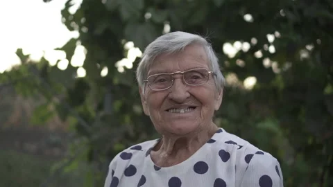 Grandma smiles at front of camera Stock Footage