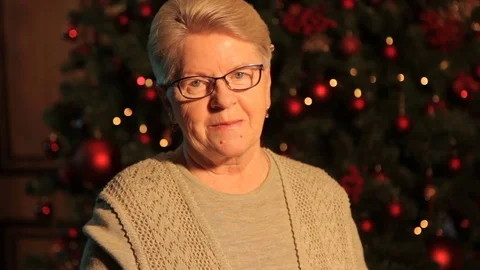 Grandma smiles while standing in front of the tree Stock-Footage 82357299
