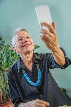 Grandma using a video chat app Stock Photos