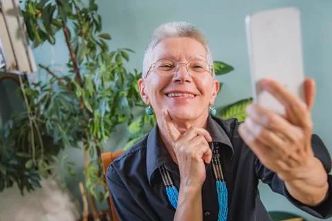 Grandma using a video chat app Stock Photos