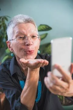 Grandma using a video chat app Stock Photos